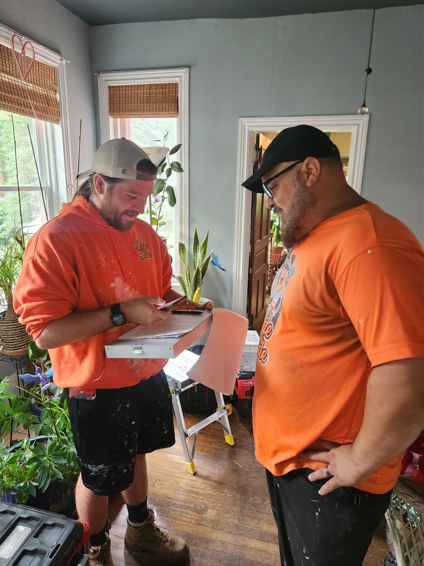 Two Side by Side crew members reviewing a work order on site