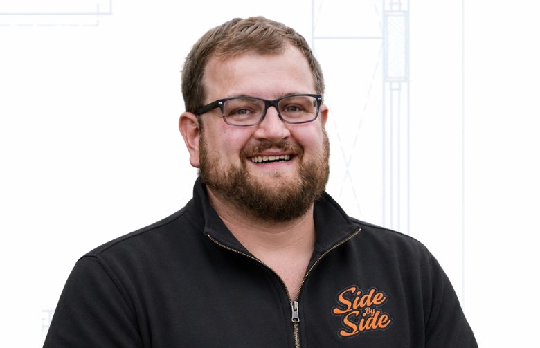 Drew Side, owner and kitchen and bath designer at Side by Side, in a black Side by Side quarter-zip
