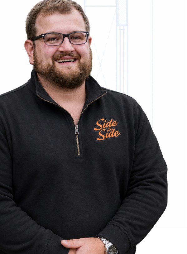 Drew Side, co-owner of Side by Side MRO, in a black Side by Side quarter-zip
